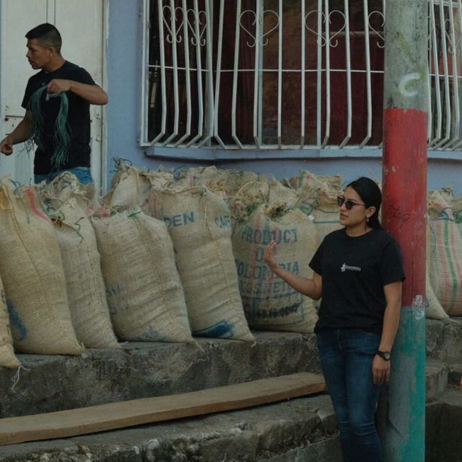 People working with sacks on a street in an urban setting
