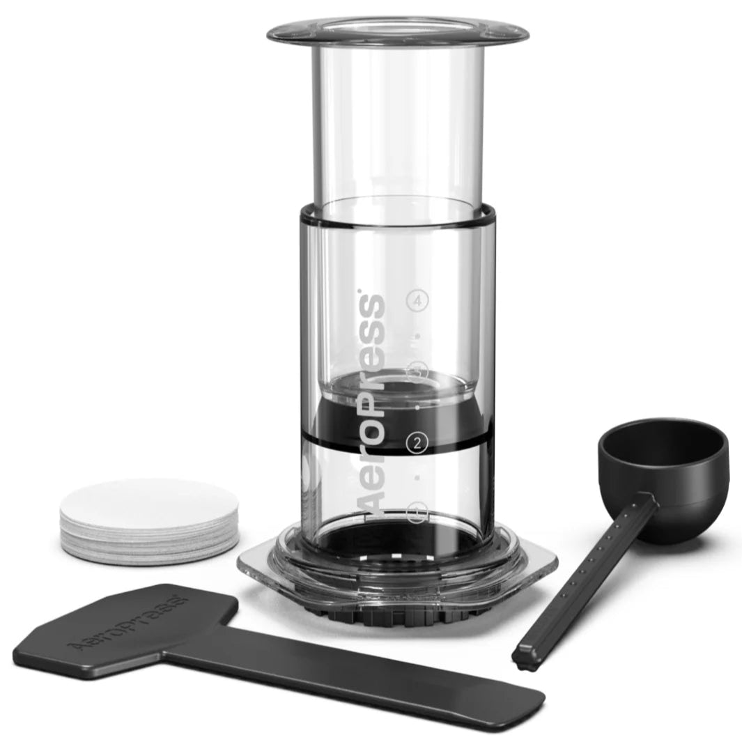 Aeropress coffee maker with components on a white background